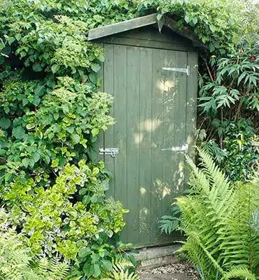 Un abri vélo caché dans la cour d'un jardin